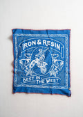 A bandana with a white graphic print featuring a motorcycle rider, wolves, and the text 'IRON & RESIN' and 'BEST IN THE WEST', displayed flat against a light off-white background.