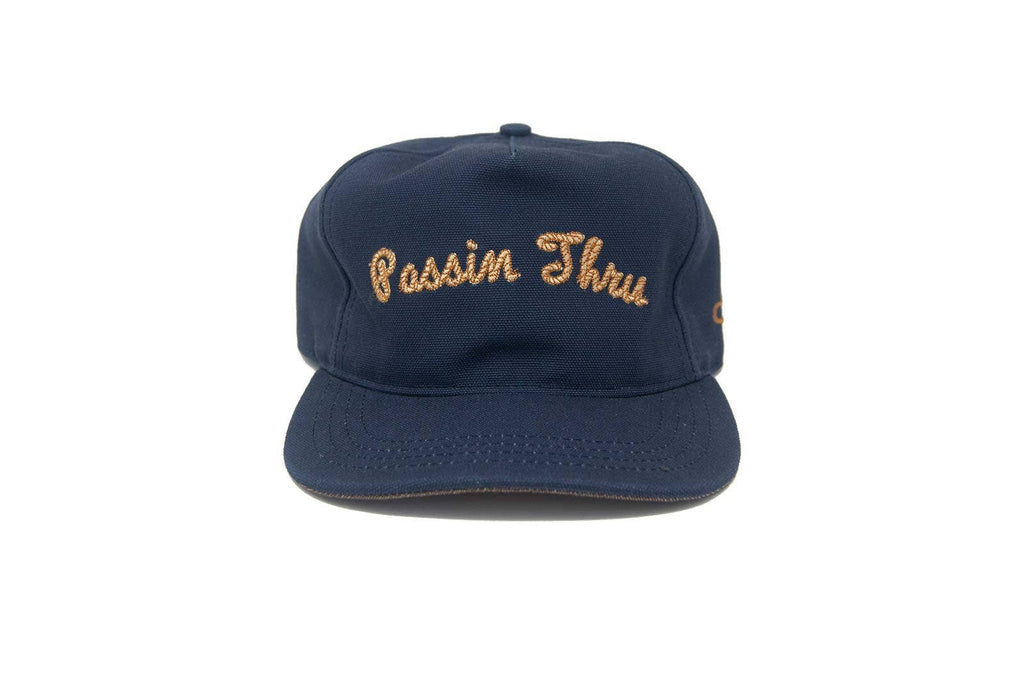 Navy blue cap with 'Passin Thru' embroidery on a white background
