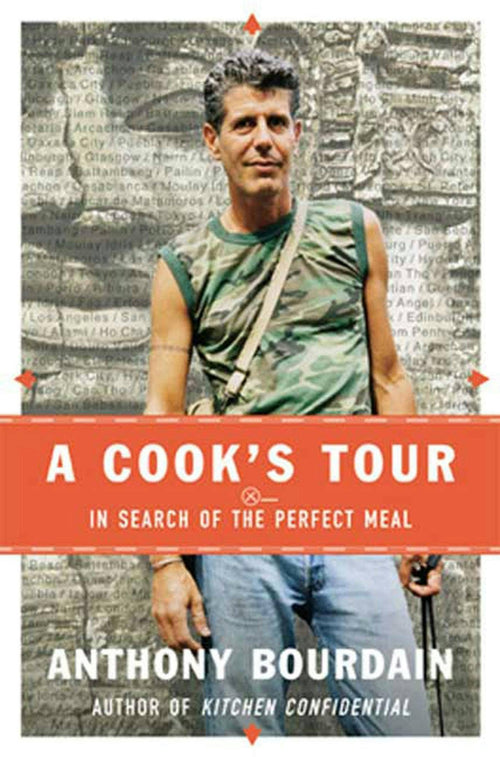 Book cover for 'A Cook's Tour: In Search of the Perfect Meal' by Anthony Bourdain, featuring a photo of Anthony Bourdain against a city street background with a bold orange-red horizontal band across the center.