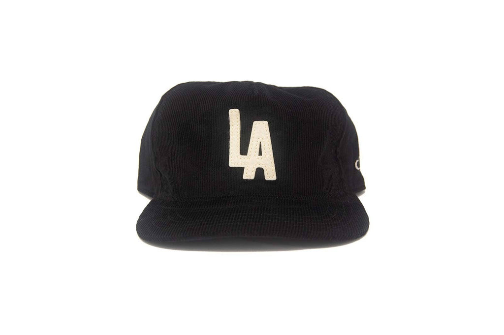 Black cap with 'LA' logo on a white background