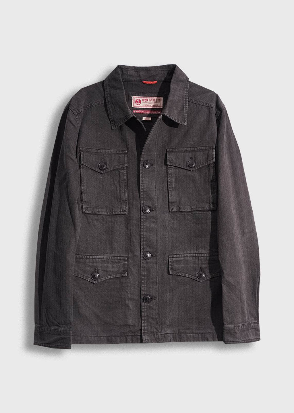 Dark gray jacket with multiple pockets on a light gray background