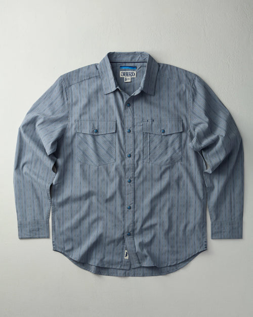 Blue button-up shirt with a collar on a light gray background