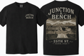 Black short-sleeve T-shirt shown from the front and back. The front has a small distressed beige 'JUNCTION & BENCH' logo on the left chest. The back features a photo of 25th St. Ogden, Utah.