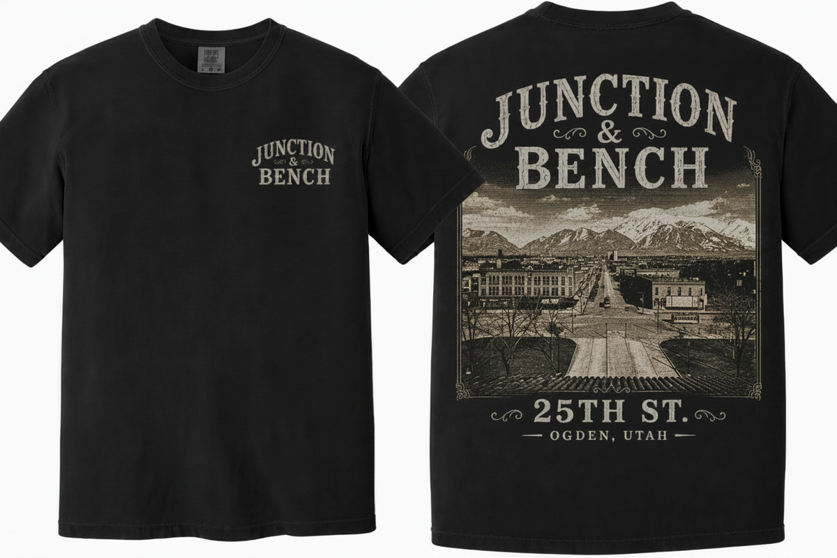 Black short-sleeve T-shirt shown from the front and back. The front has a small distressed beige 'JUNCTION & BENCH' logo on the left chest. The back features a photo of 25th St. Ogden, Utah.