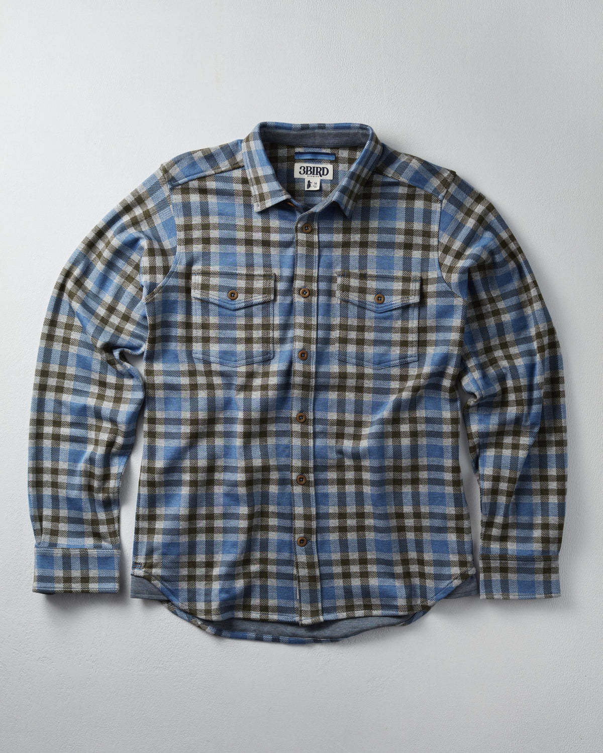 Plaid shirt with visible brand logo on a gray background