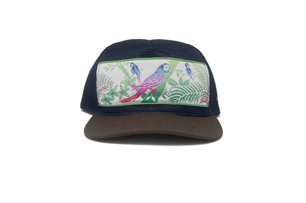 Trucker hat with bird and leaf design on a white background
