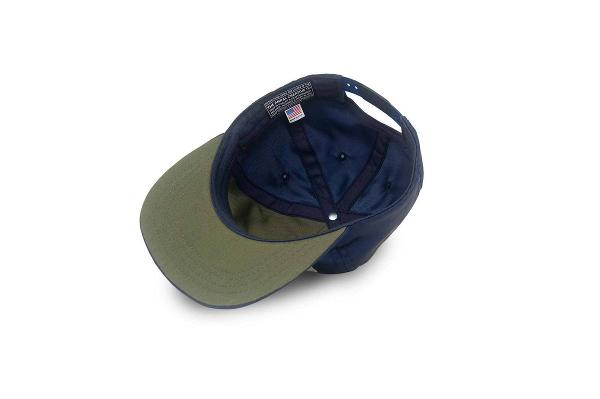 Two baseball caps, one green and one navy, on a white background