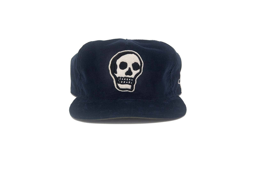 Navy blue cap with a white skull design on a white background