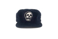 Navy blue cap with a white skull design on a white background