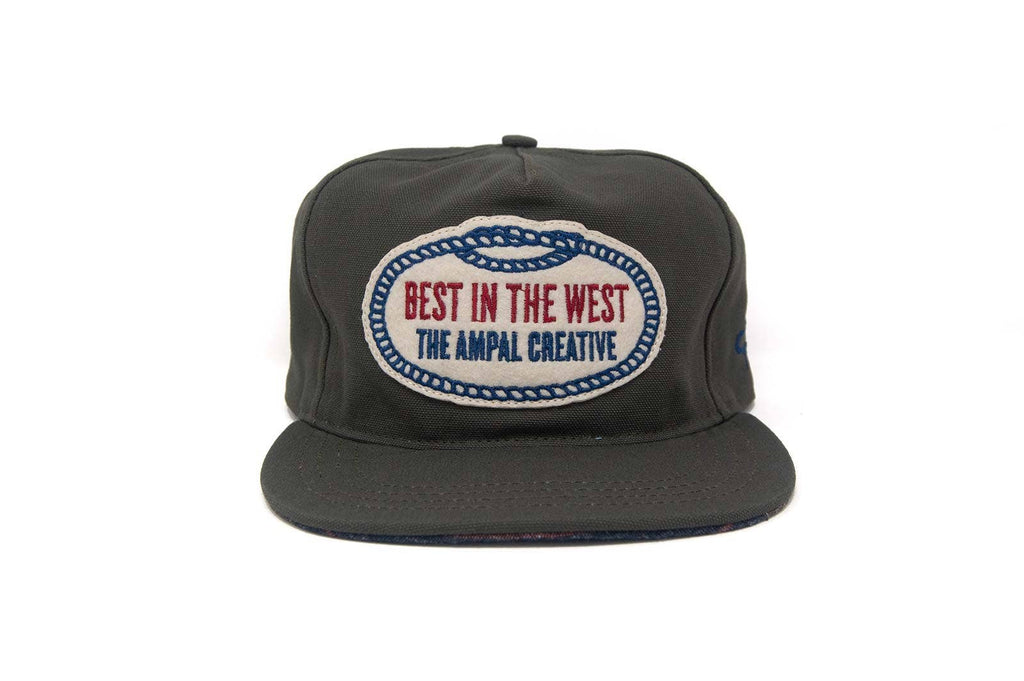 
dark grey cap with 'Best in the West The Ampal Creative' logo on a white background