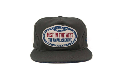 
dark grey cap with 'Best in the West The Ampal Creative' logo on a white background