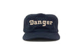 Navy blue cap with 'Danger' text on a white background