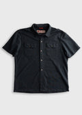 Black short-sleeve shirt with button details on a light gray background