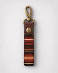Keychain with colorful patterned strap and gold clasp on a white background